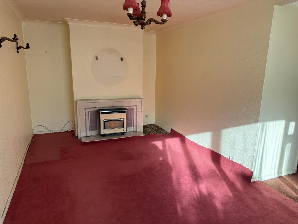 Lot: 87 - TWO-BEDROOM FLAT WITH GARAGE IN NEED OF UPDATING - Living room with fireplace